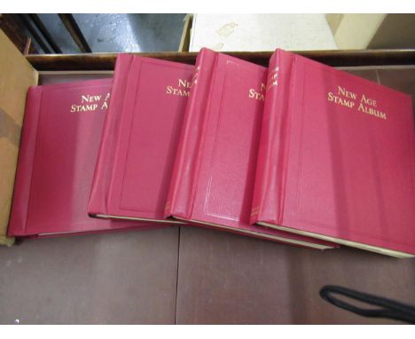 Four red New Age stamp albums containing an extensive collection of mint and used G.B., Commonwealth and World stamps 