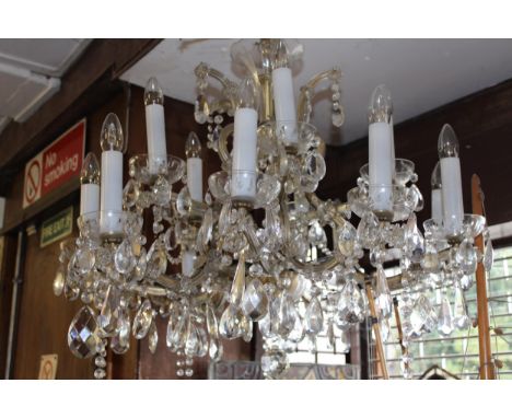 Mid 20th Century glass and gilt brass fifteen light electrolier, the shaped arms with multiple prismatic drops and swags, 28i