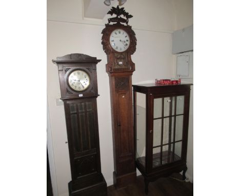 19th Century Continental oak longcase clock, the floral carved hood with a bar glazed pendulum window above a rectangular pan