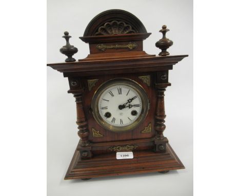 Late 19th Century walnut mantel clock by Junghans, the ceramic dial with Roman numerals and a two train movement striking on 