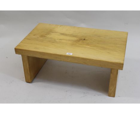 Modern sycamore coffee table with a plank top and block end supports, 29.5ins x 15.5ins together with a modern light oak wall