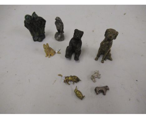 Miniature bronze figure of a dog, 2.5ins high together with four various similar figures and four similar charms 