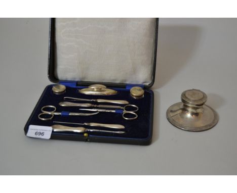Cased silver handled manicure set and a silver capstan inkwell 