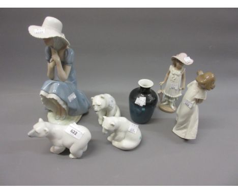 A group of three Lladro figures of polar bears, Lladro baluster form vase and three Nao figures of a woman and two children (