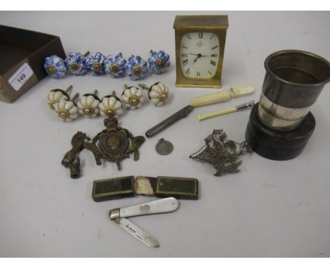 Bag containing a miscellaneous quantity of items to include:  a mantel clock, military folding plated cup, silver fruit knife