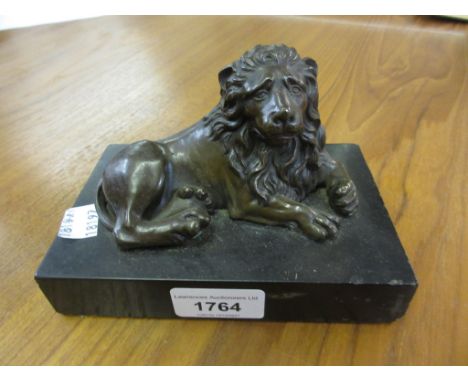 Brown patinated bronze figure of a recumbent lion , mounted on a slate base, 6ins x 4ins x 4ins high overallSmall scratch on 