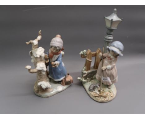 Lladro figure of a girl sweeping leaves beneath a street lamp, 13ins high together with a similar figure of a girl with bird 
