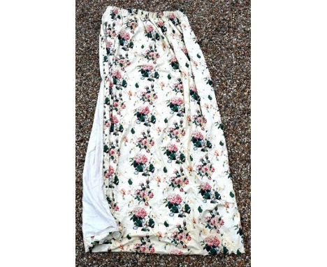 A pair of interlined glazed cotton curtains printed with floral designs, 264 cm drop x 90 cm each