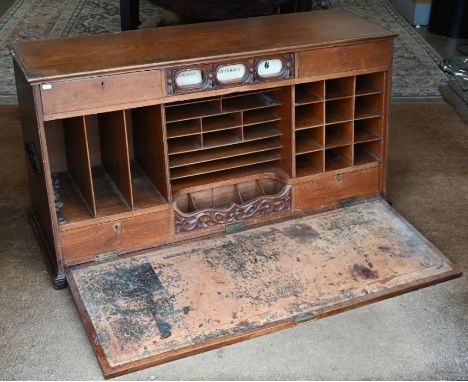 An early 20th century mahogany bureau cabinet with fall-front panel enclosing fitted interior below windowed date-displaying 