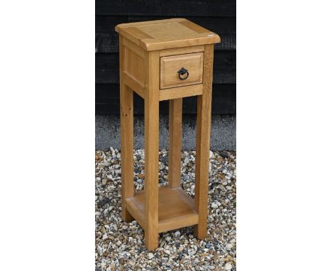 A modern light oak lamp table with single drawer and open undertier, 28 x 28 x 82 cm high
