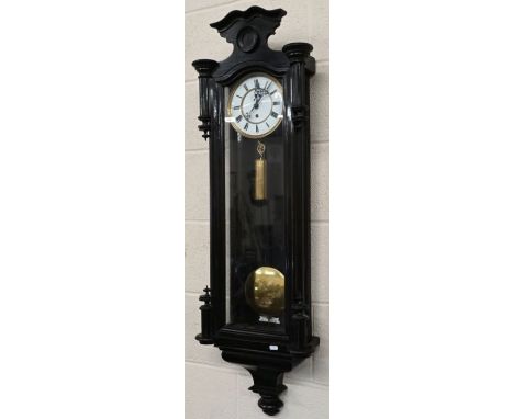 A large Vienna style single train wall clock with glazed ebonized case, c/w pendulum and weight, 170 cm high o/a&nbsp;