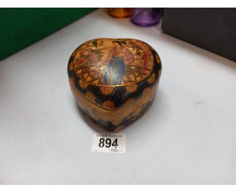 An oriental style heart shaped pottery trinket box