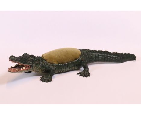 A Bergman style cold painted bronze pin cushion in the form of a crocodile, 23cm long.