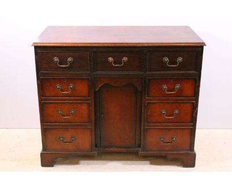 20th century mahogany veneered kneehole desk with an arrangement of three drawers above three cupboard drawers (two with faux