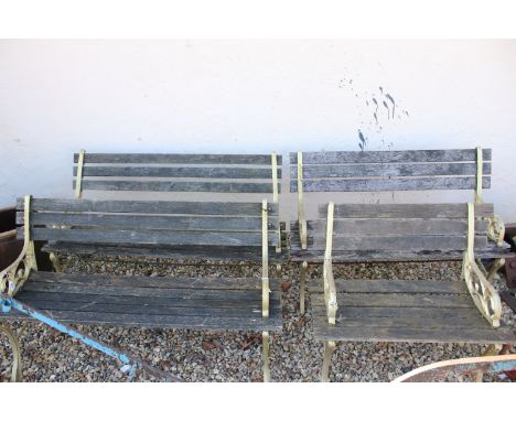 Set of four garden benches each having cast iron bench ends with slatted seats, largest measures W 122cm