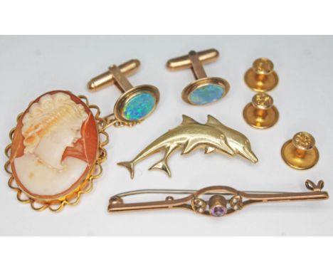 A mixed lot of 9ct gold comprising a mounted cameo brooch, a dolphin brooch, a pair of cufflinks set with opals, three button