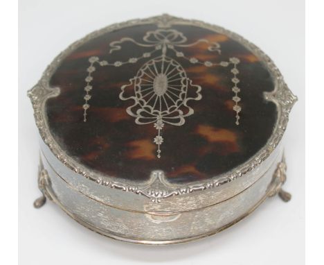 A hallmarked silver and tortoiseshell trinket box, diam. 11.5cm.  Condition - marks rubbed, possible repair to two feet and p