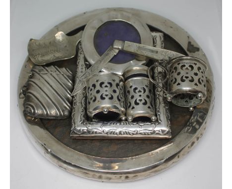 A quantity of hallmarked silver comprising three photograph frames, a three piece cruet, a mother of pearl and silver bladed 