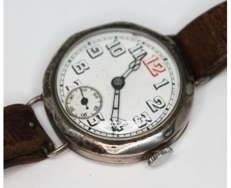 A 1930s silver cased trench style manual wind wristwatch with unsigned white dial, Arabic numerals and seconds subsidiary dia