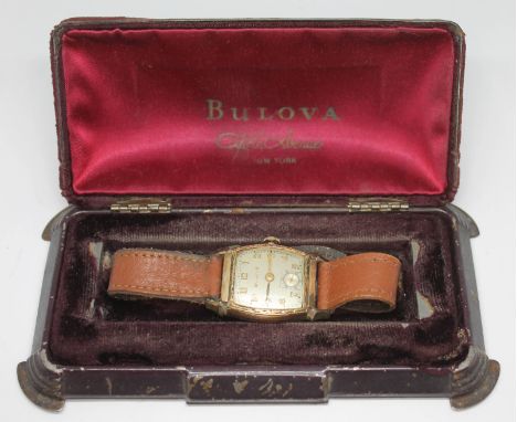 A 1940s Bulova Watch Co Art Deco style gold plated manual wind wristwatch with signed champagne dial, gold Arabic numbers and