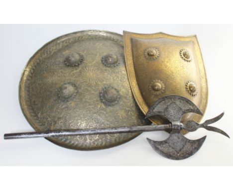 An Indo-Persian dhal shield of typical round form, diam. 40cm, together with another of shield shape and an axe head, length 