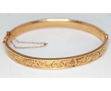 A 9ct gold bangle, marked '9ct', approx. diam. 5.5cm, wt. 7.9g.Condition: a couple of dents to bangle as pictured, clasp ok.
