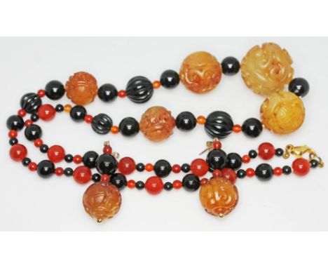 A Chinese single strand of multi-coloured beads including five carved jade, with clasp marked '9K', length 57cm, together wit
