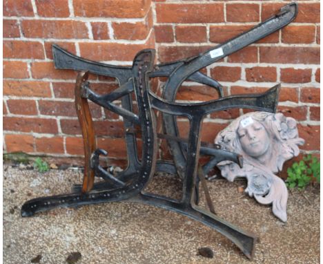 Two cast metal bench ends and a flower girl wall mount