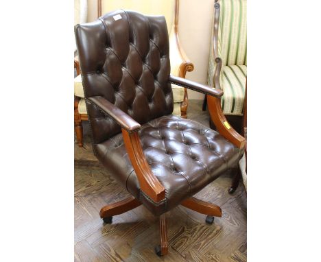 A modern leather button back office armchair on swivel base