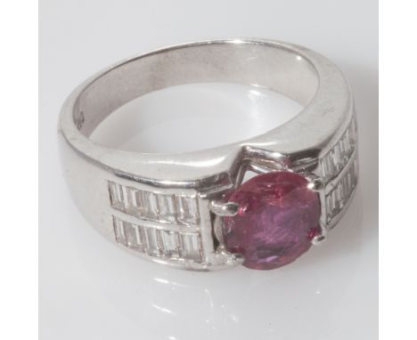 Large 18ct white gold ruby and diamond band ring, set with oval ruby and baguette cut pave diamonds. Shank stamped 750. Ring 