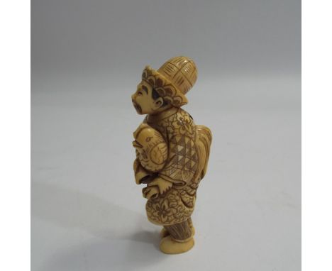 Large early 20th C Japanese carved ivory netsuke in the form of a man holding a hen, signed to the base, 8.5cm high  Conditio