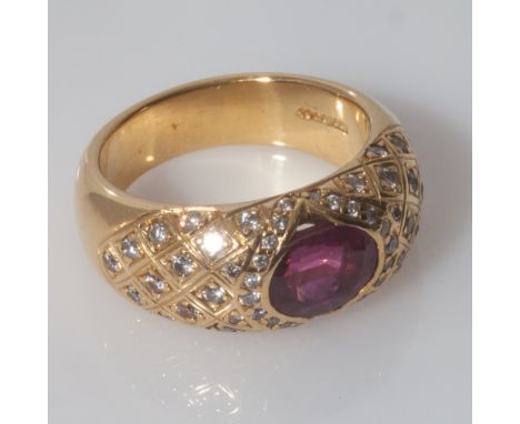 Large and impressive ruby and diamond ladies ring, set with an oval ruby, with pave diamond set wide 18ct yellow gold band. G