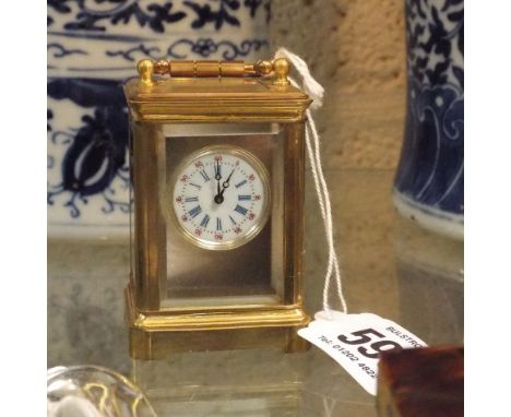 Miniature French carriage clock with silvered face and white enamel dial, 8cm high including handle  Clock does run. Does not
