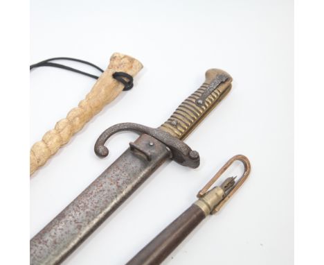 French bayonet in scabbard, cattle prod and a whip 