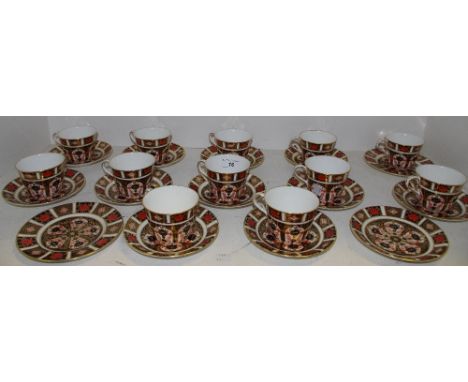 A Royal Crown Derby 1128 Pattern Tea Service For Twelve, comprising teacups and saucers.
