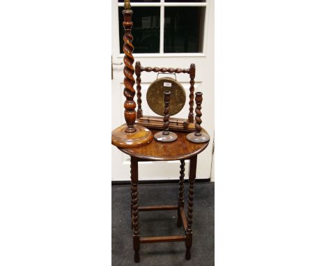 A circular oak occasional table gong; candlesticks; lamp base, barley twist columns (5)