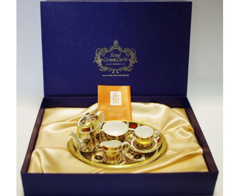 A Royal Crown Derby 1128 imari pattern miniature tea set, comprising teapot, cream jug, sugar bowl, cup and saucer, on oval t