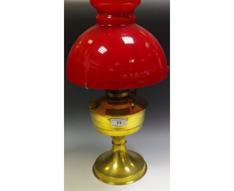 An Aladdin 23 oil lamp with scarlet glass shade.