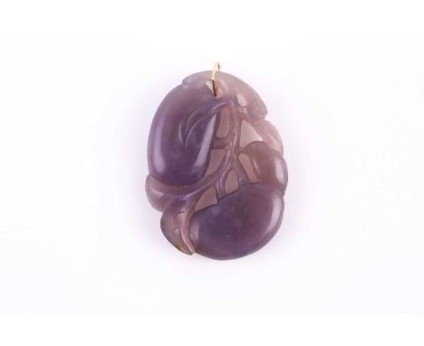 A Chinese carved purple jade or chalcedony pendant, carved with plums, leaves and a bird, with yellow metal suspension loop. 