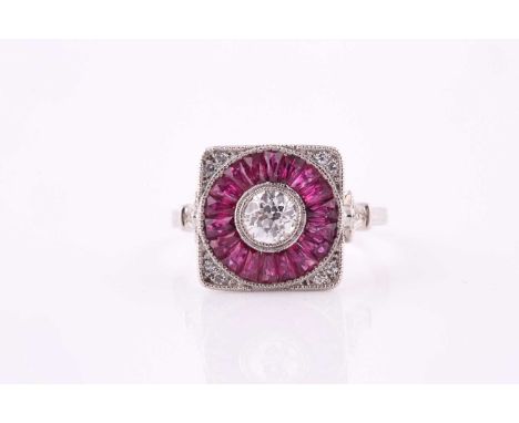 A ruby and diamond panel ring, the central 5mm diameter round brilliant cut diamond within a ruby set surround, millegrain se