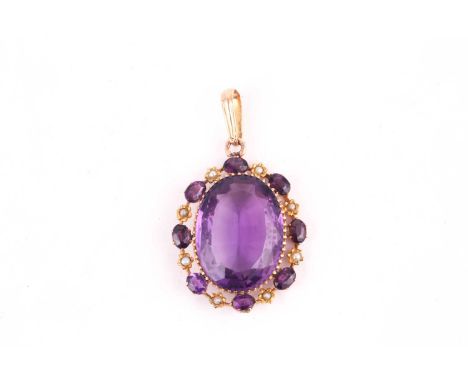 A oval amethyst and seed pearl pendant, set with a 25x20mm oval amethyst surrounded by further oval amethysts alternating wit