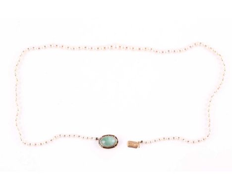 A single strand cultured pearl necklace, pearls graduated from 3.2-7.2mm, with oval jade cabochon and seed pearl clasp, Conti