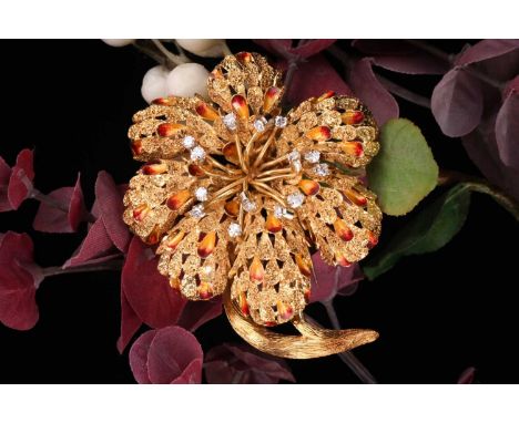 A diamond and enamel flower head brooch, set with 8-cut diamonds weighing an estimated 0.40ct and enamel leaves of red and ye