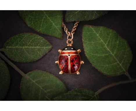 A yellow metal and enamelled pendant in the form of a ladybird, overall 3cm long on a yellow metal 24inch rope chain.Conditio