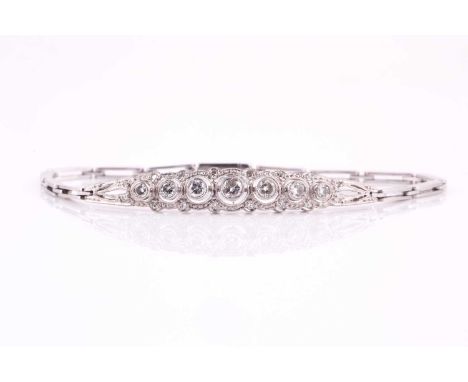 A circa 1950's diamond bracelet, with rub over set round brilliant cut and 8-cut diamonds with an estimated weight of 1.00ct 