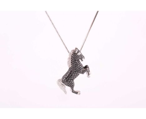 A black and white diamond horse pendant, set in white metal on a fancy link chain, stamped 585, black diamond weight approxim