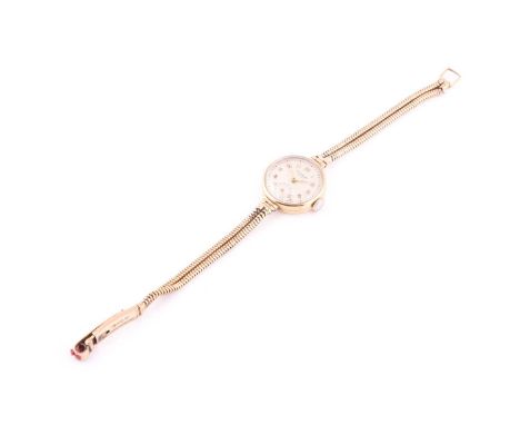 A Universal Geneva 21mm case, hand-wound movement yellow metal watch with white dial and Arabic numerals and seconds at 6 O'c