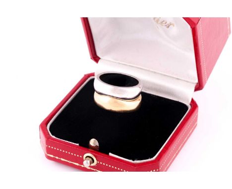 A Cartier 'Love Me' set of two band rings, one in polished yellow and one in polished white gold, stamped 'Cartier 57 750', a