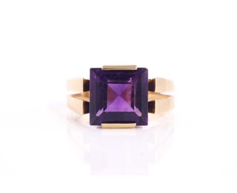 A square amethyst dress ring, set with a square step-cut amethyst on a raised split shank mount on yellow metal stamped 585, 