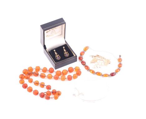 A pair of amethyst and pearl earrings, an amber bracelet, an amber necklace, a bangle and a brooch. The 9ct gold earrings con